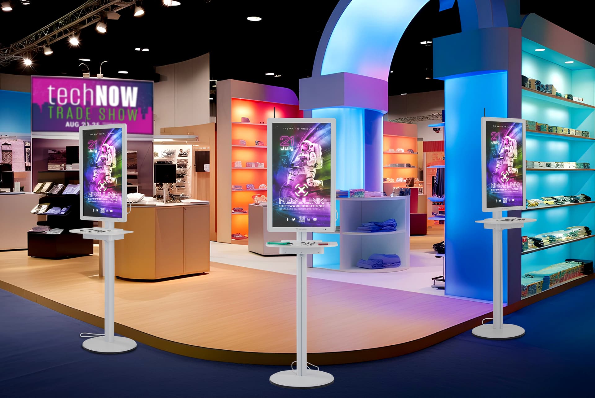 Digital charging station with three units being showcased in a trade show setting with a software company advertisement space
