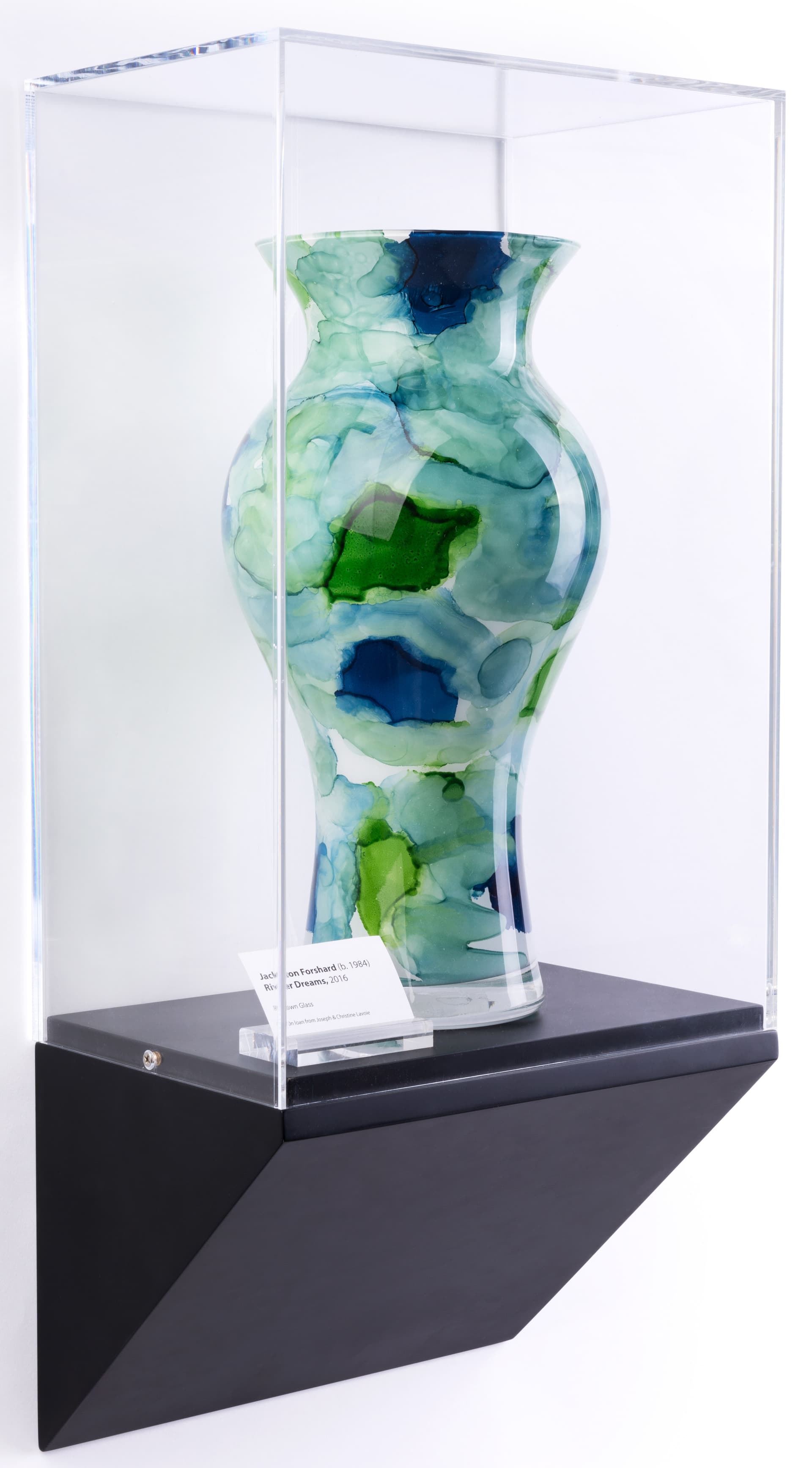 Wedge pedestal wall display case shown with vase