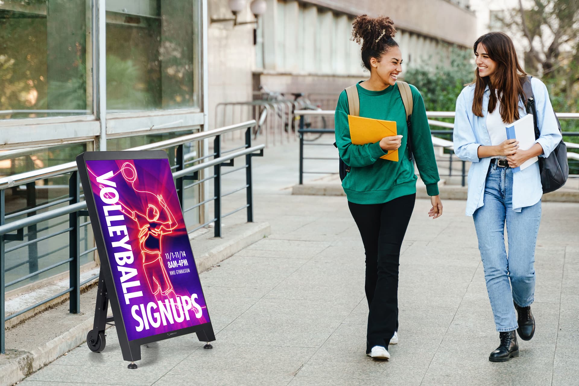 Digital sidewalk sign being showcased outside in a college environment thanks to the IP55 weather-resistant rating