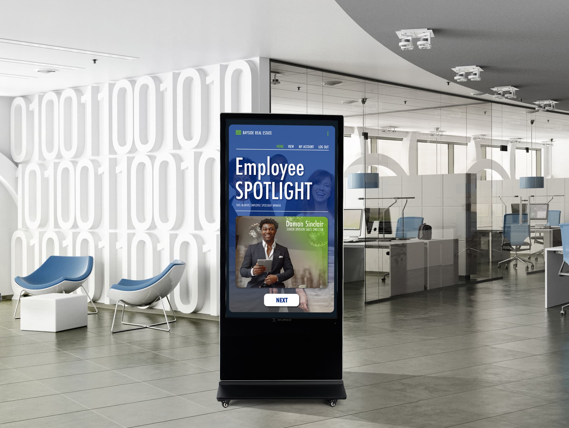 Advertising multimedia kiosk in a corporate office space showcasing an employee spotlight graphic