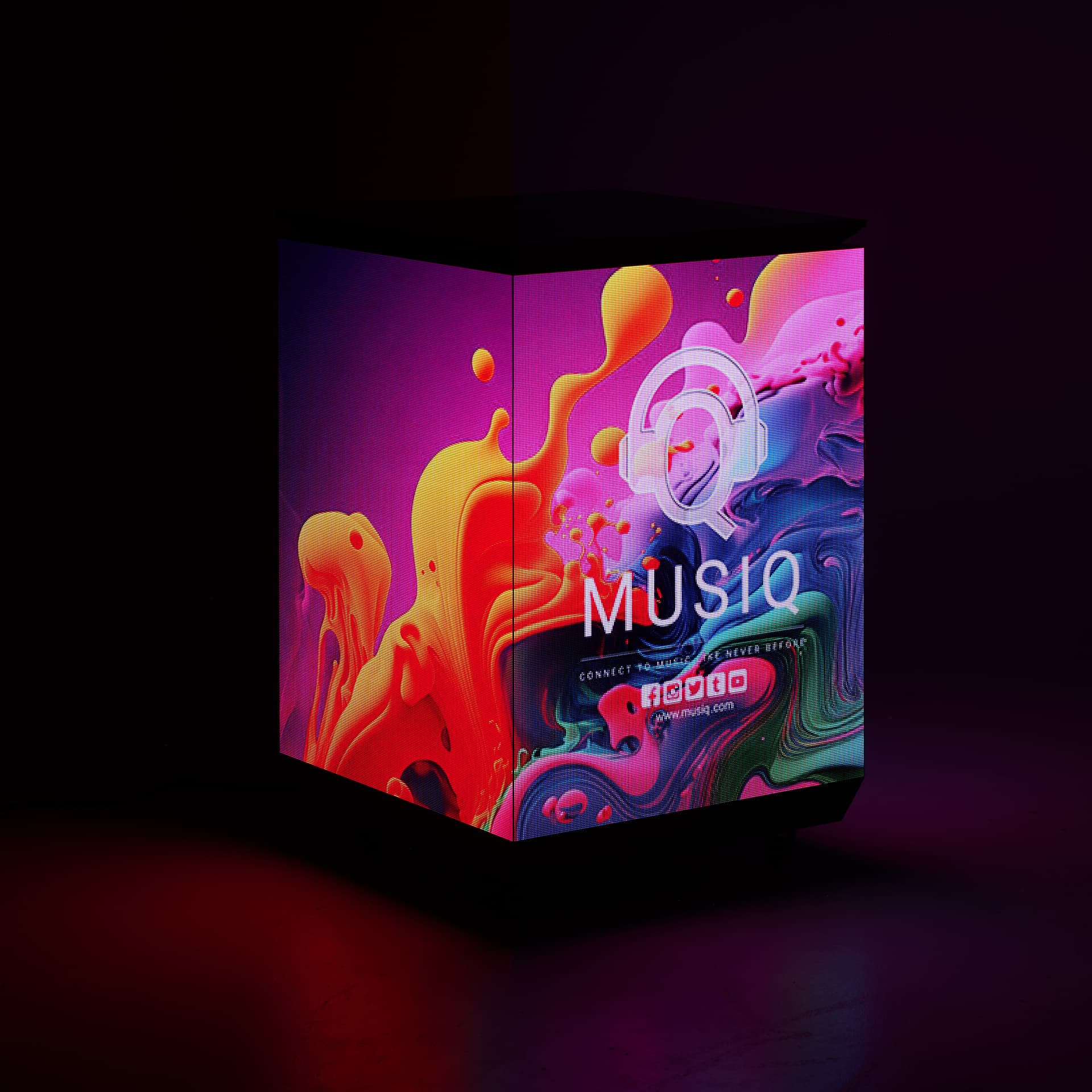 Three-sided digital signage totem being exhibited in a dark room showing its bright and vibrant display