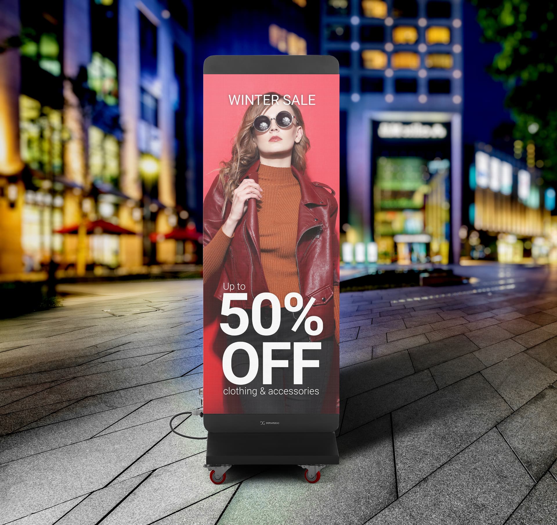Direct view LED display being showcased in an outdoor shopping plaza displaying a graphic for a sale at a retail clothing store