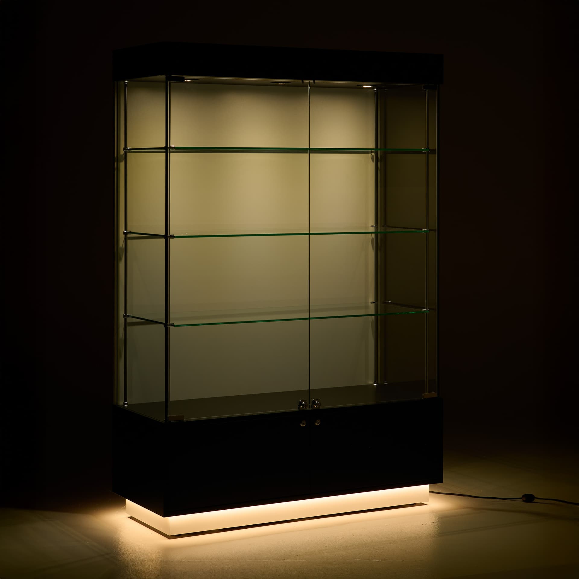 Light up display case with illuminated interior and toe-kick