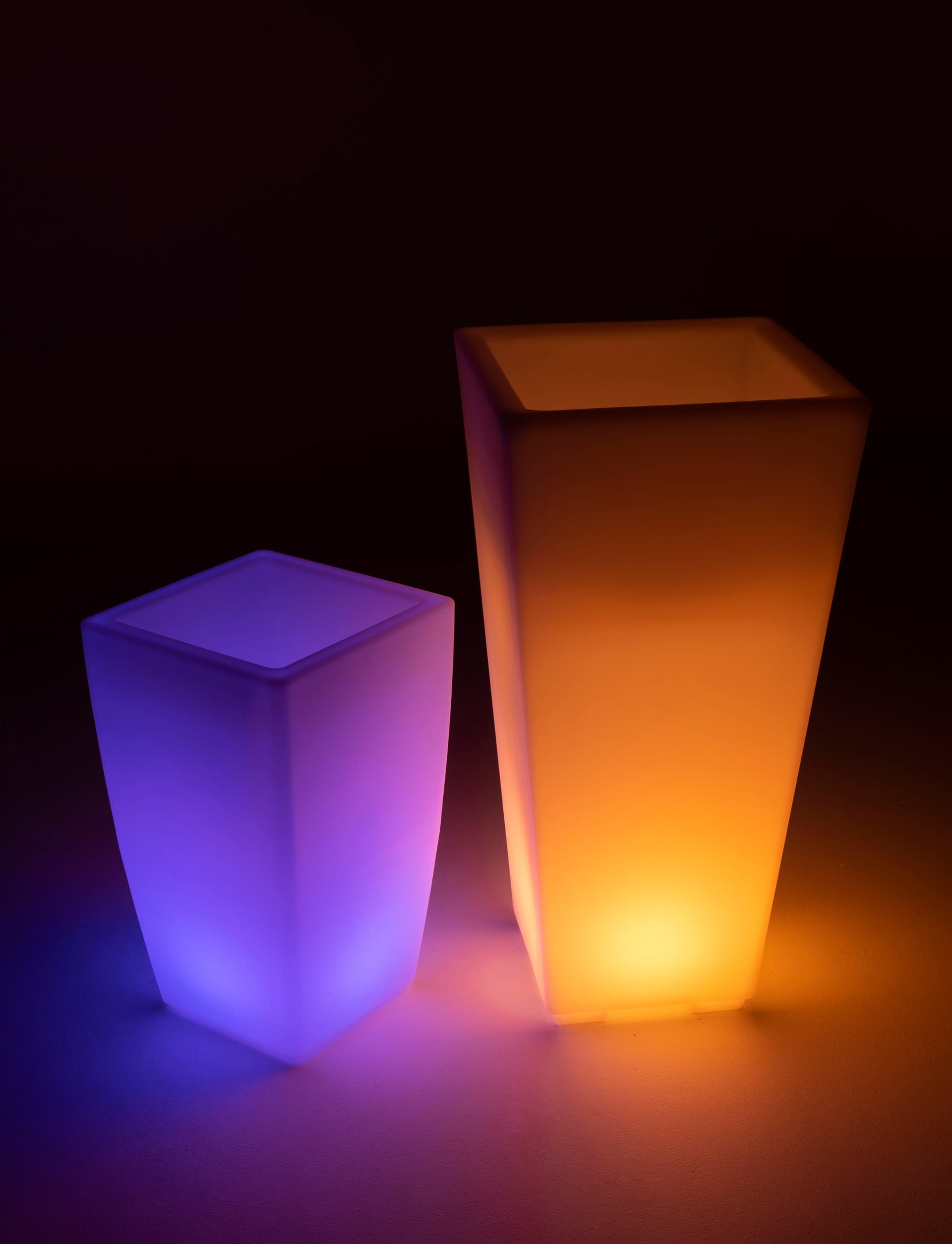 Large LED ice bucket pot next to small planter