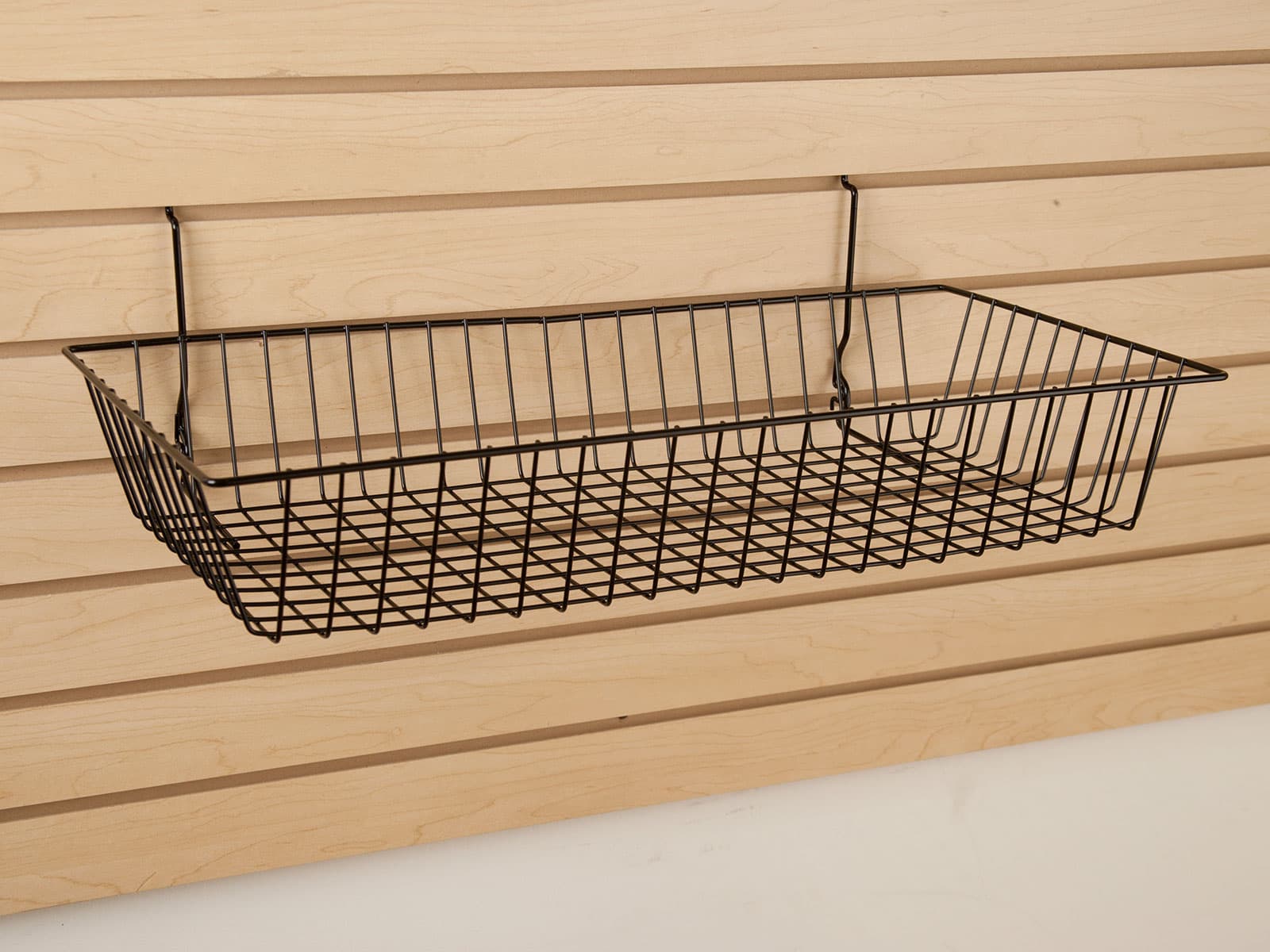 Wire basket assembly on maple-colored slatwall