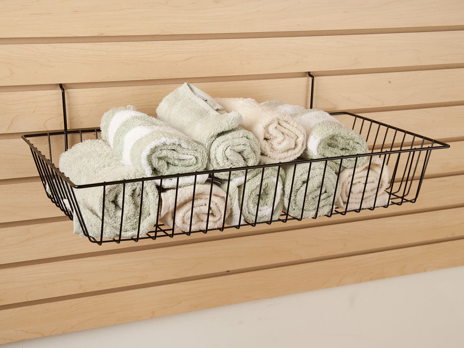Wire slatwall basket stocked with towels
