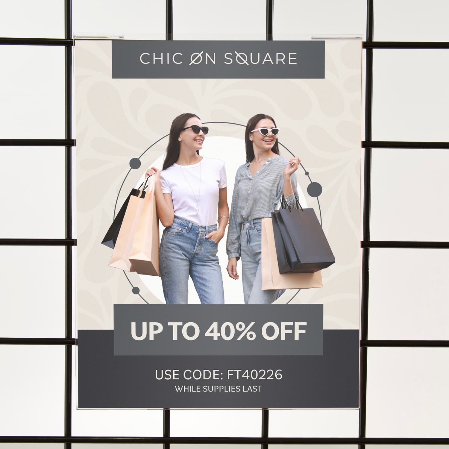Acrylic gridwall sign holder being shown on a gridwall advertising a retail clothing sale