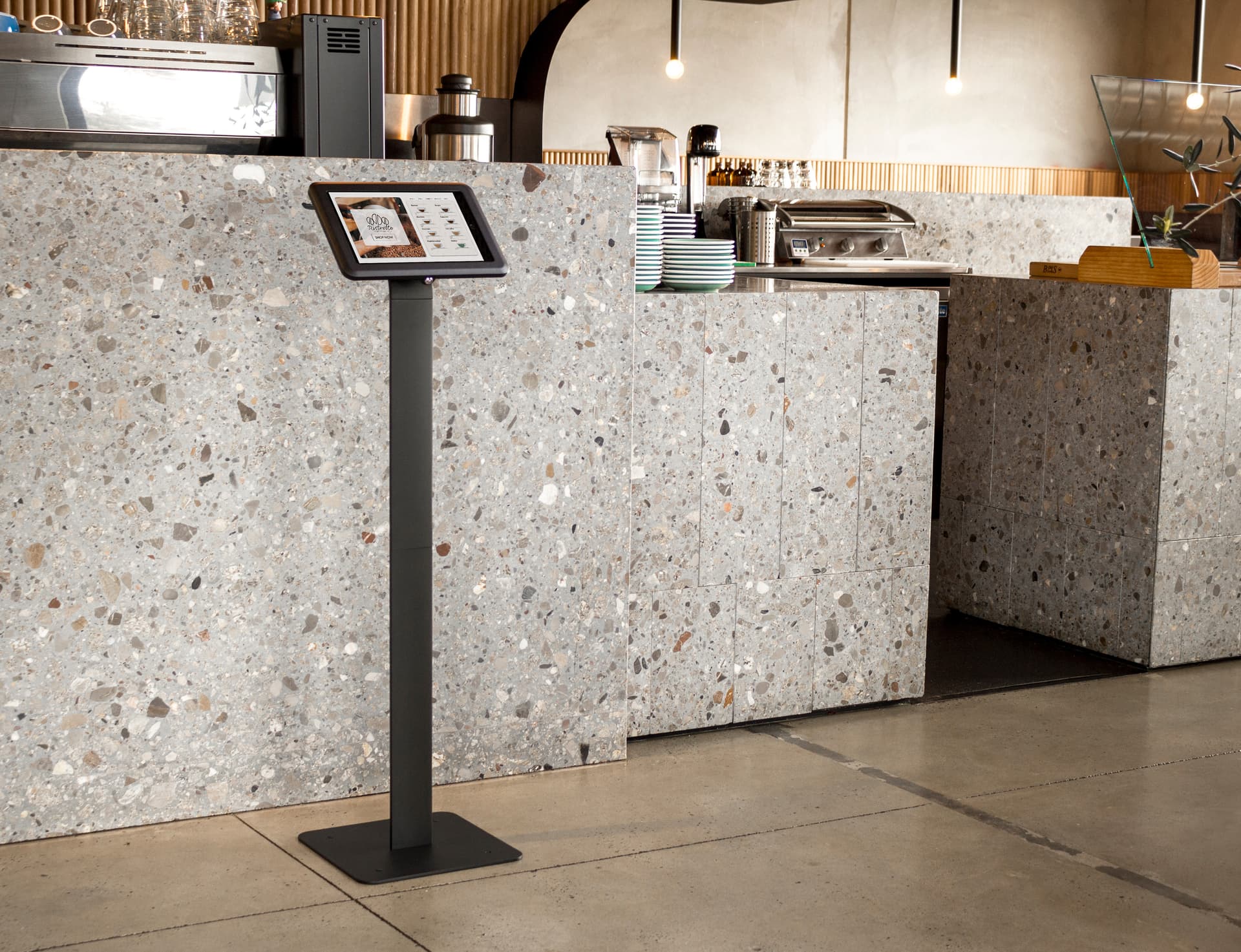 IPad kiosk stand being showcased in a restaurant as a POS system