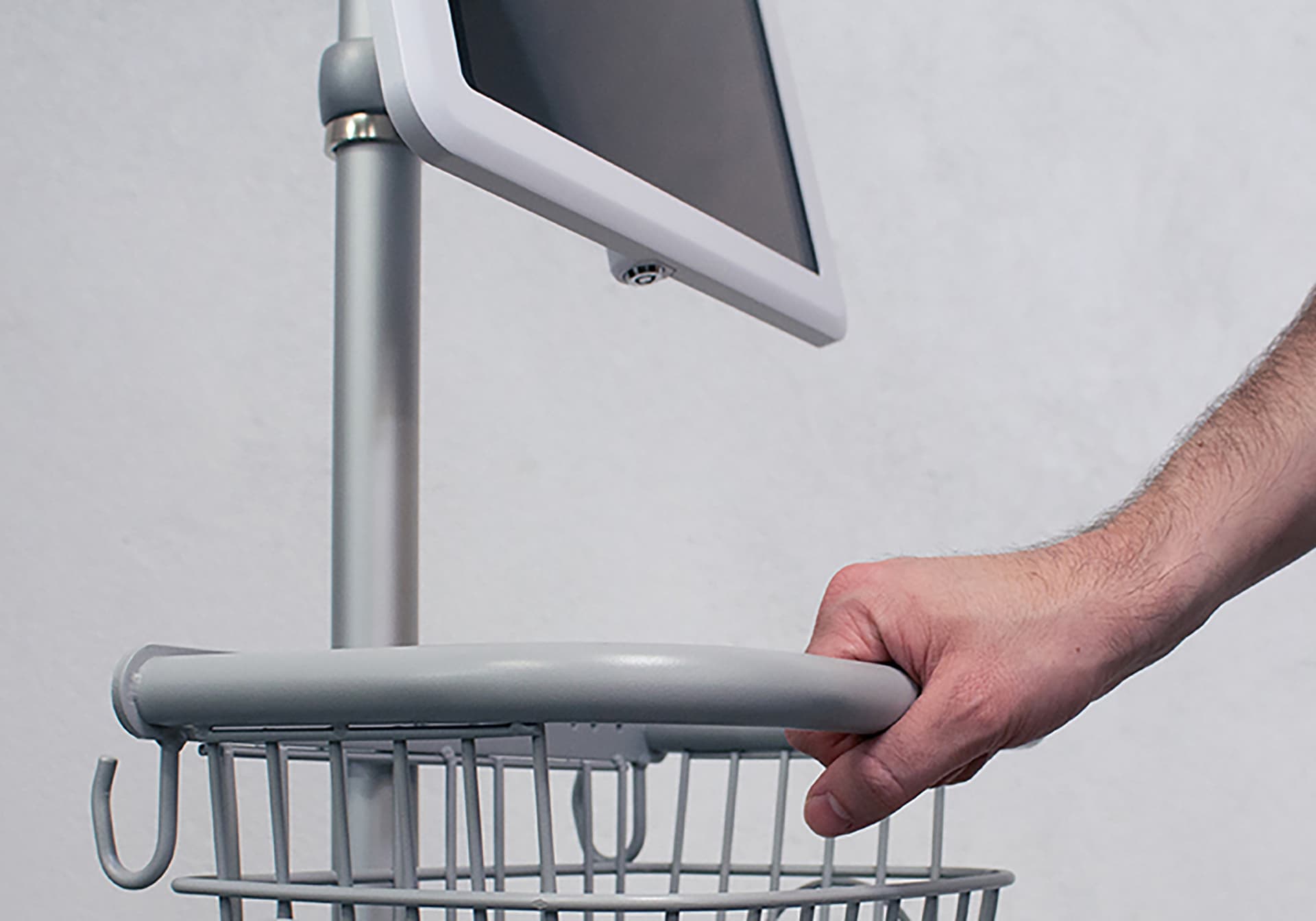 Medical mobile iPad cart with an individual pushing the medical cart via the basket