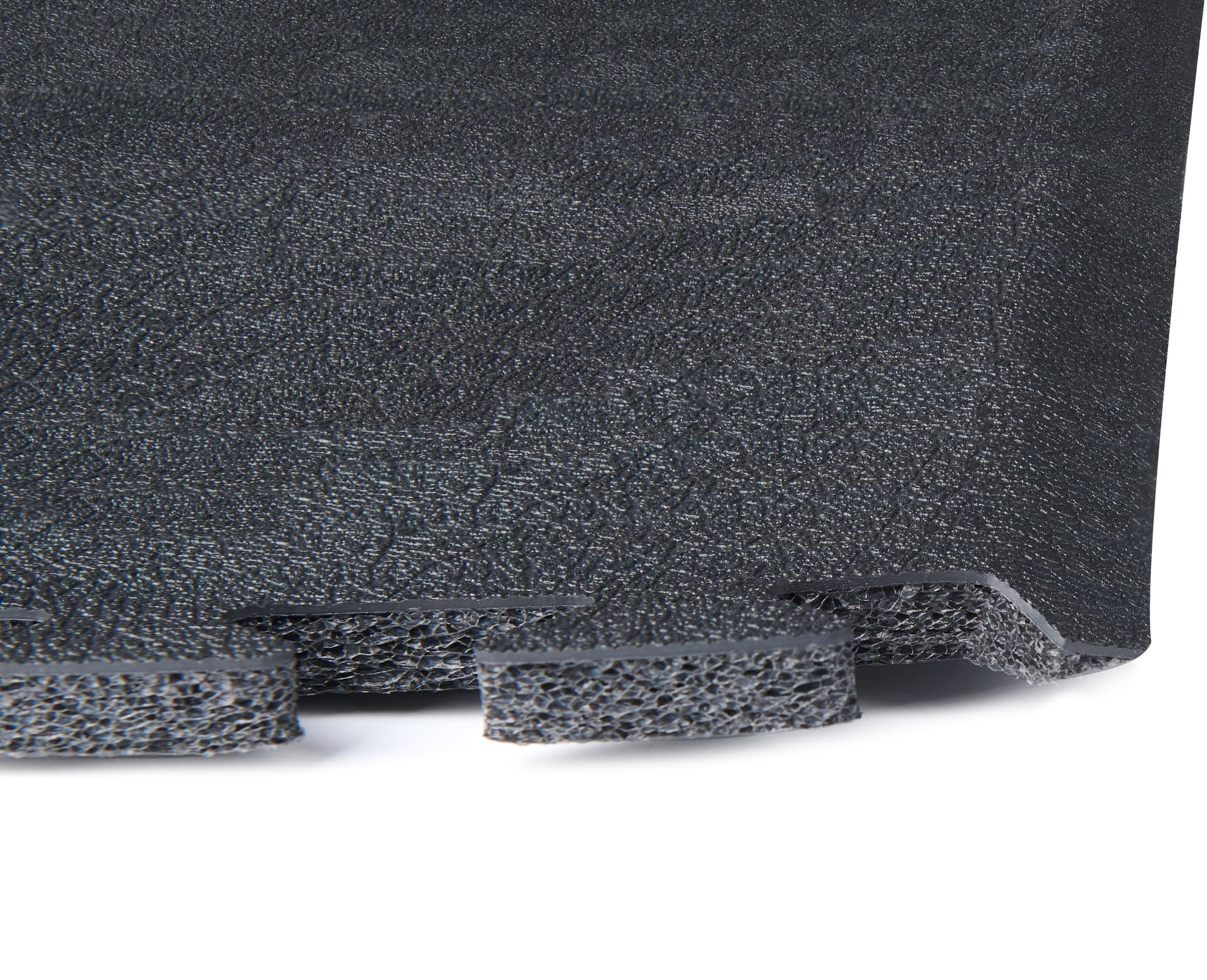 Interlocking foam mats exhibiting the layering of foam, vinyl finish, and beveled edge of one square