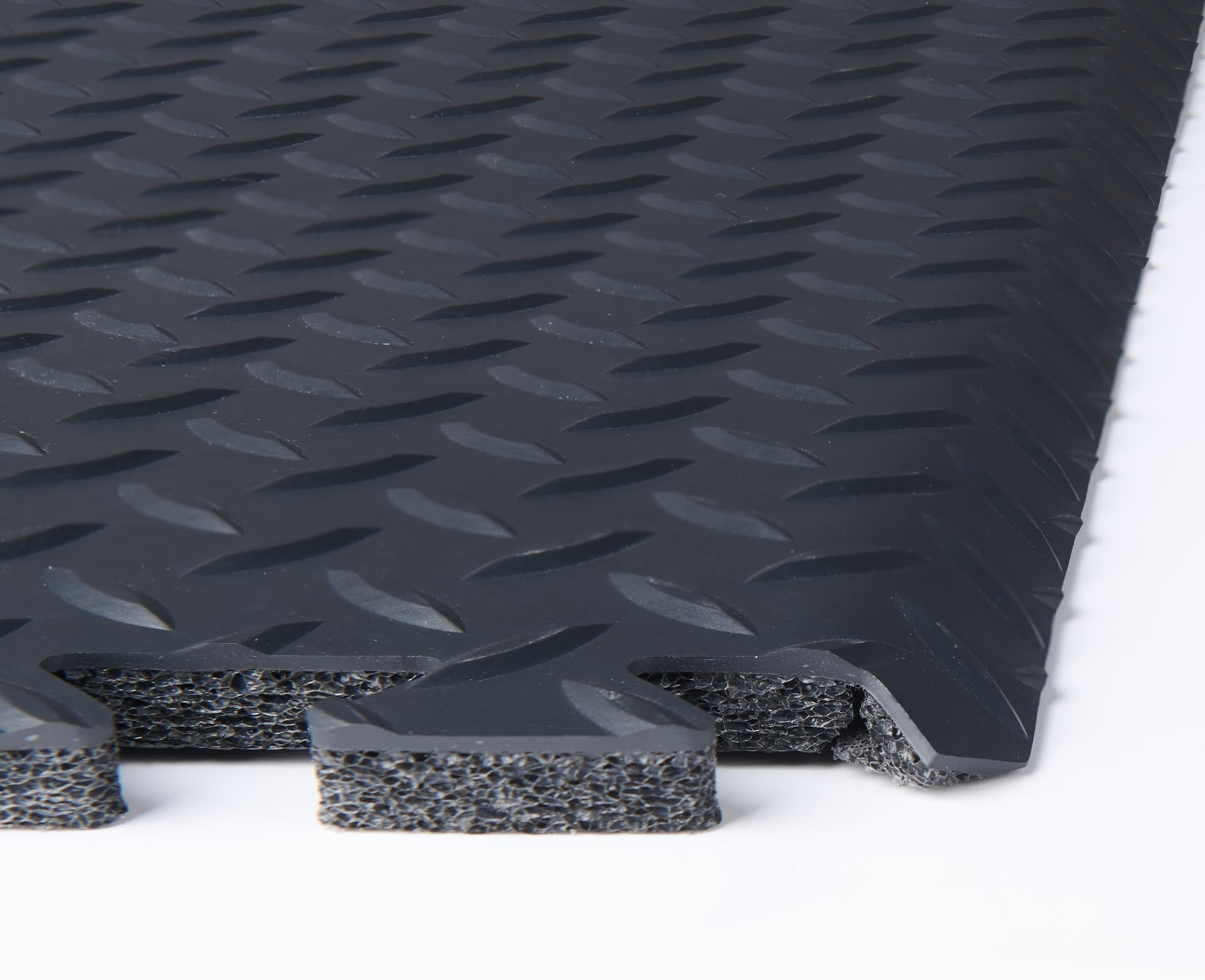 Trade show floor tiles exhibiting the layering of foam, vinyl finish, and beveled edge of one square
