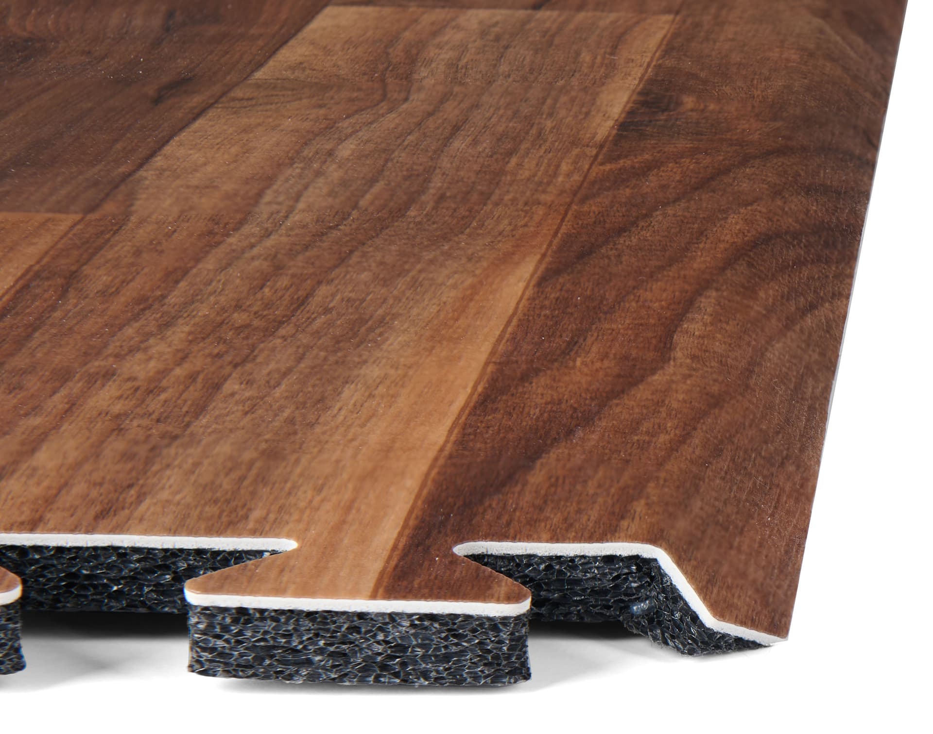 Trade show booth flooring exhibiting the layering of foam, vinyl finish, and beveled edge of one square