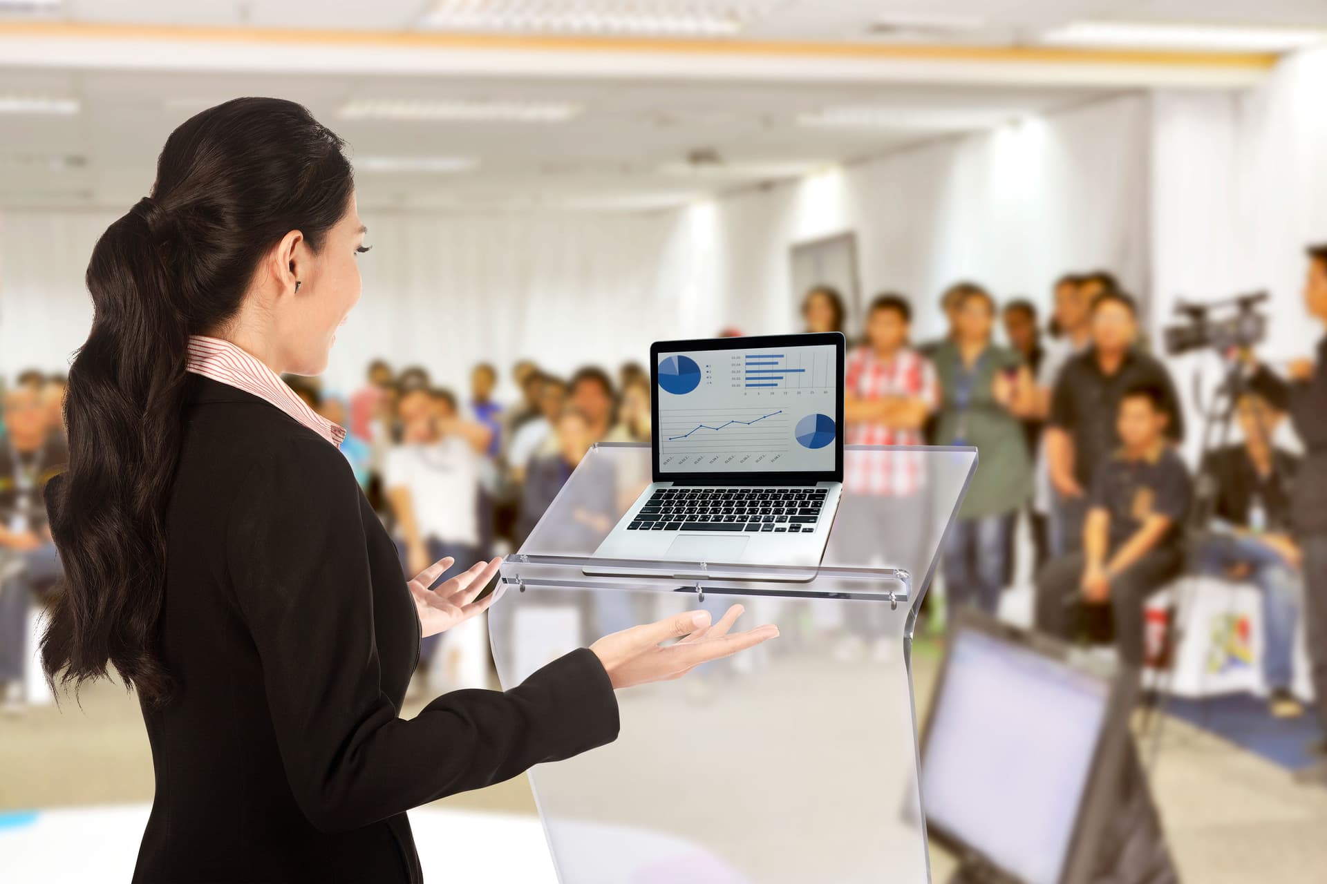 Clear acrylic Z shape podium holds laptops and notebooks