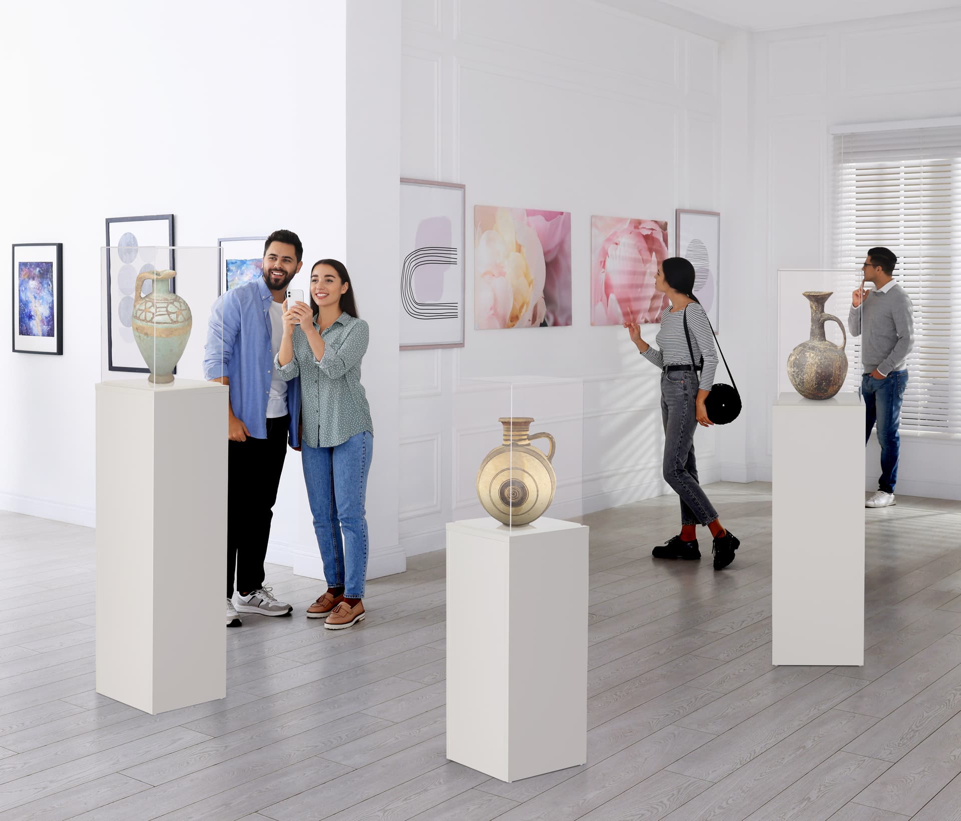 White display pedestal showcasing artifacts in gallery setting