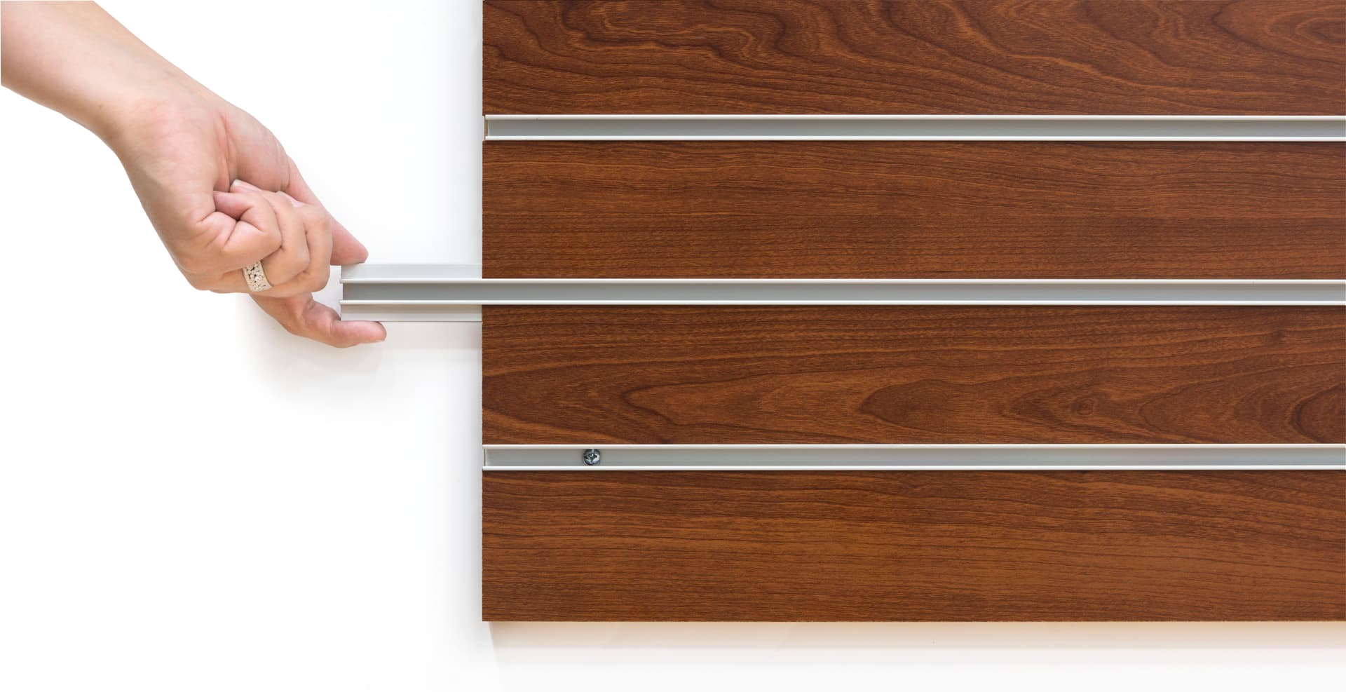 Hand Pulling out Slot Insert of  the Cherry Finish Large Slotted Wall Board Panel