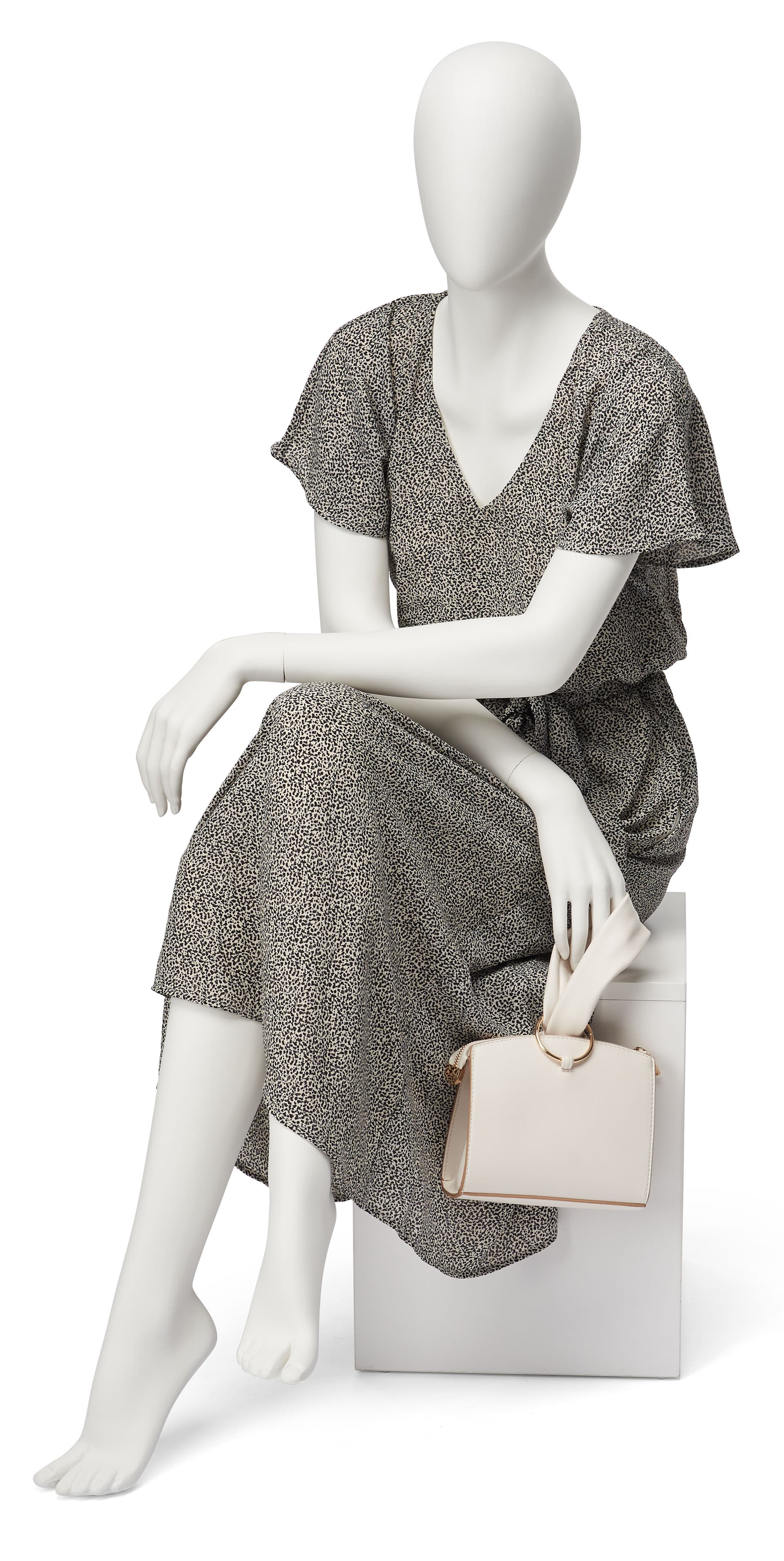 Abstract seated female mannequin with relaxed sitting pose
