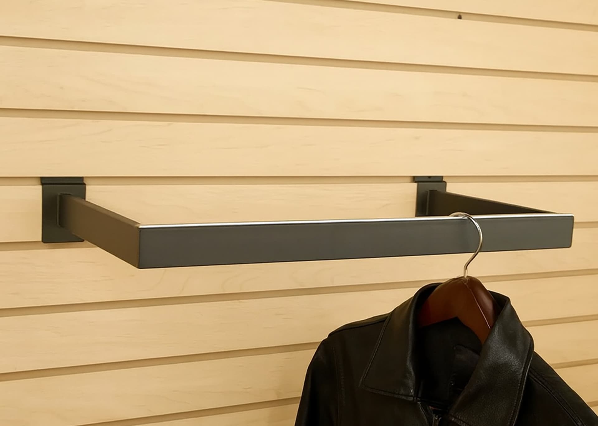 Slatwall U-shaped hangrail mounted on a retail slatwall