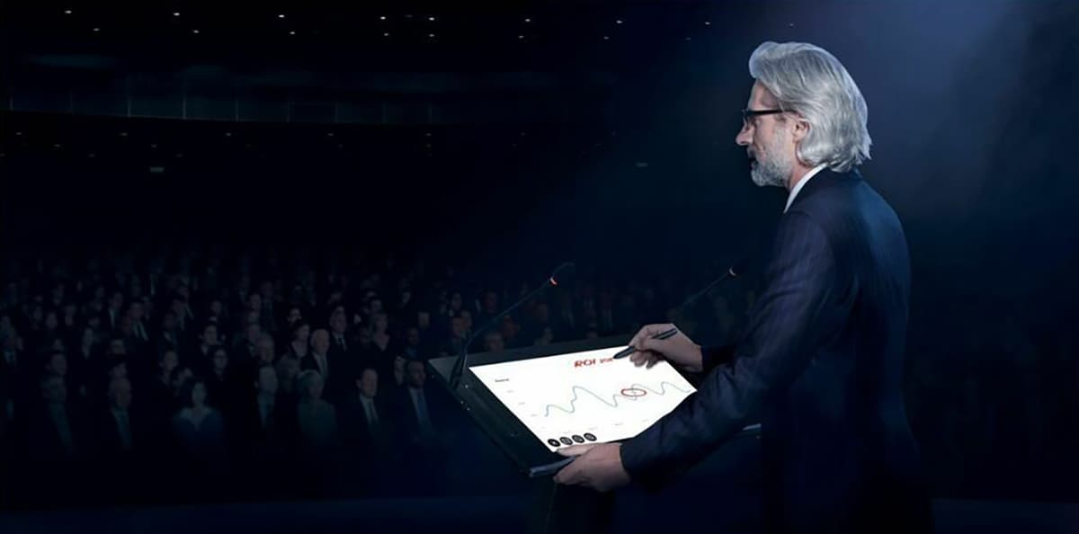 Smart digital podium showing a man present in front of a large crowd