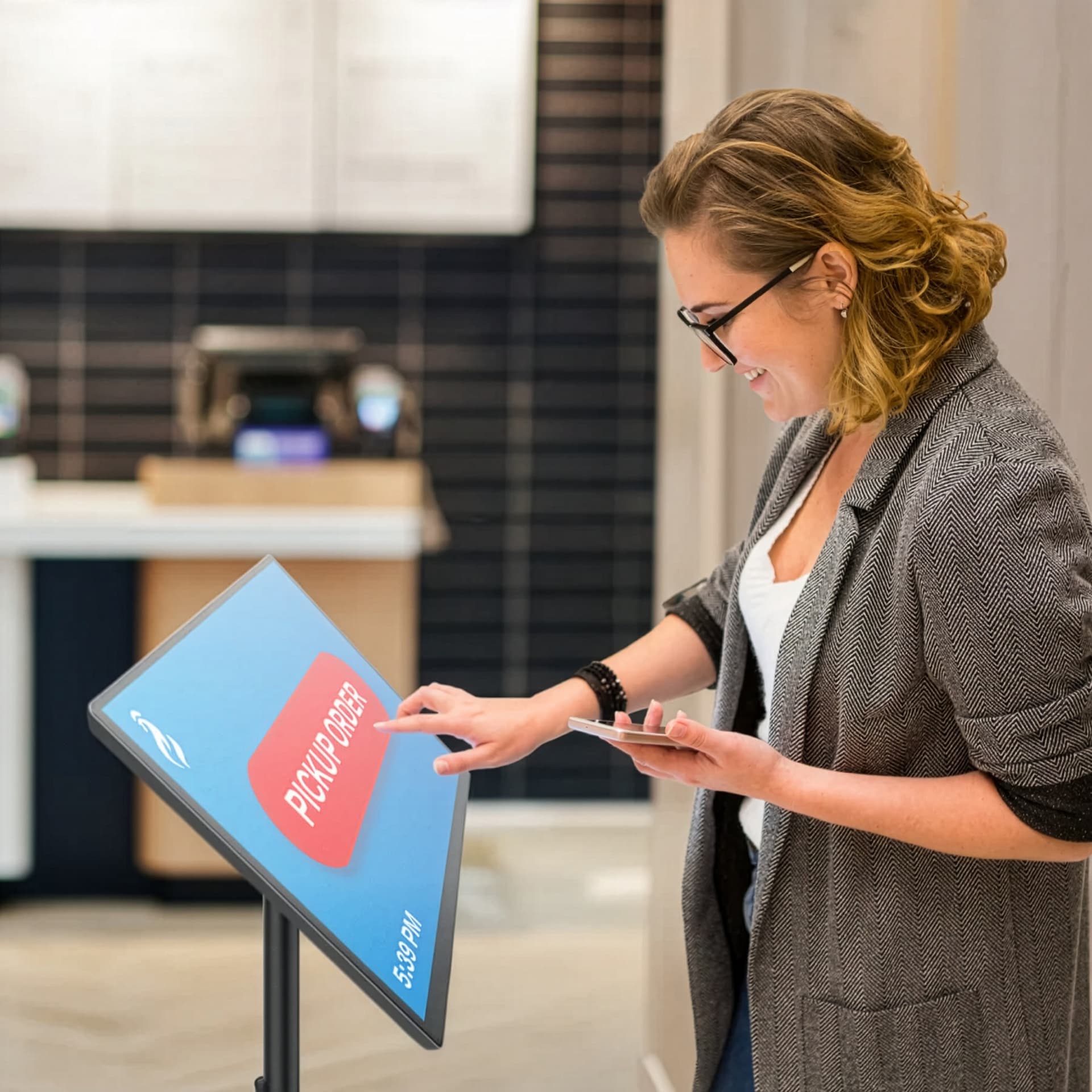 Mobile rechargeable kiosk exhibiting an individual using the unit for a self service order pick up