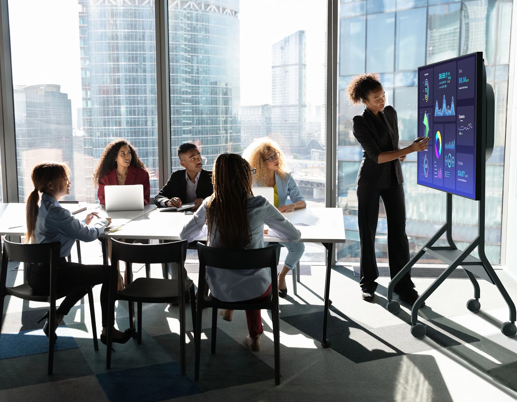 Mobile TV cart being used in a boardroom setting