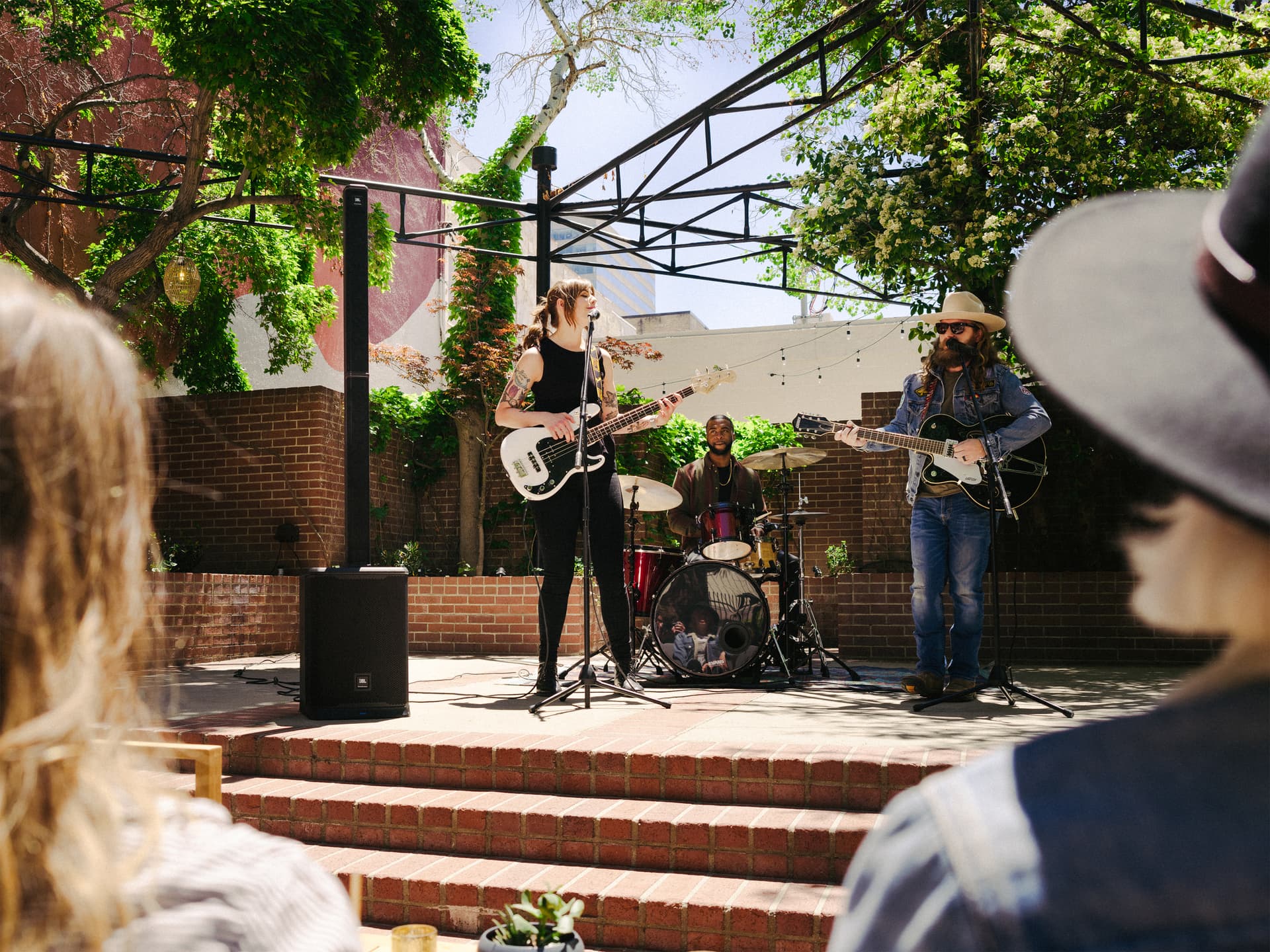 JBL column speakers being utilized in an outdoor music venue powering an outdoor performance
