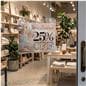 Glass mount sign holder attached to the door of a retail shop