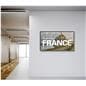 Digital signage monitor in an office environment for a travel agency displaying travel promotions to France