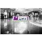 Edge lit horizontal touch screen kiosk shown in busy shopping center space