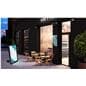 Portable outdoor digital signage on sidewalk at restaurant in night setting