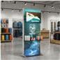 Double-Sided Lightbox Monitor Stand with Shelving in a retail store