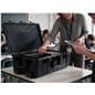 Teacher distributing devices from tablet charging cart in classroom