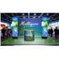 Digital advertising display being showcased in a trade show booth peering above the crowd and gathering attention