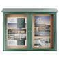 Outdoor enclosed bulletin board exhibiting graphics advertising a real estate agency 