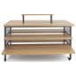Tiered display table with wheels and oak colored veneered MDF shelves