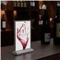 Tabletop LED sign holder shown on a bar in a restaurant setting
