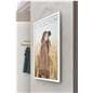Digital signage ePaper showcasing a clothing ad on a wall mounted unit in a retail store front