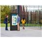 Outdoor digital signage display with double-sided screens being viewed in a public setting
